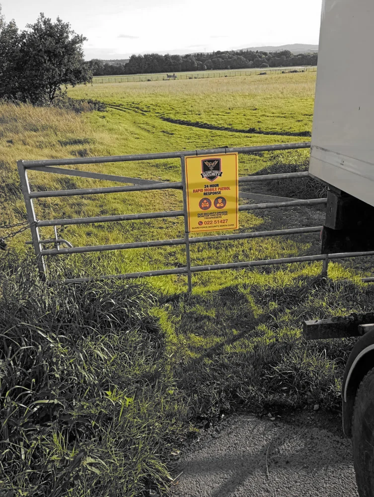 Guard Force Security key holding sign at a rural property gate in North Cork