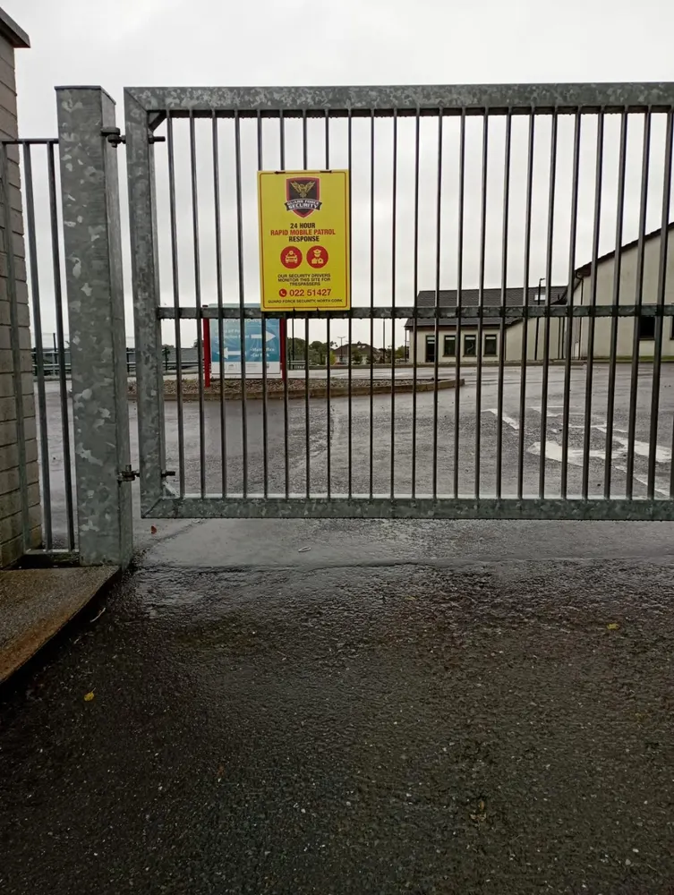 Guard Force Security patrol sign at an industrial gate in the Millstreet coverage area
