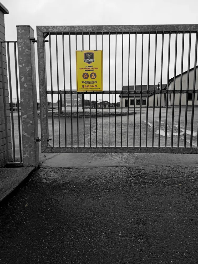 Guard Force Security patrol sign at an industrial gate in the Millstreet coverage area