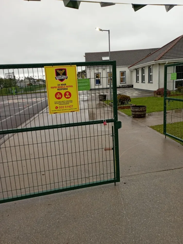 Guard Force Security patrol signage at a primary school gate in North Cork