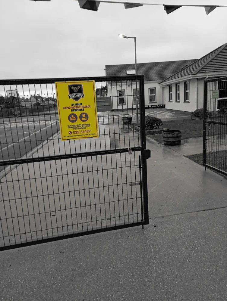 Guard Force Security patrol signage at a primary school gate in North Cork